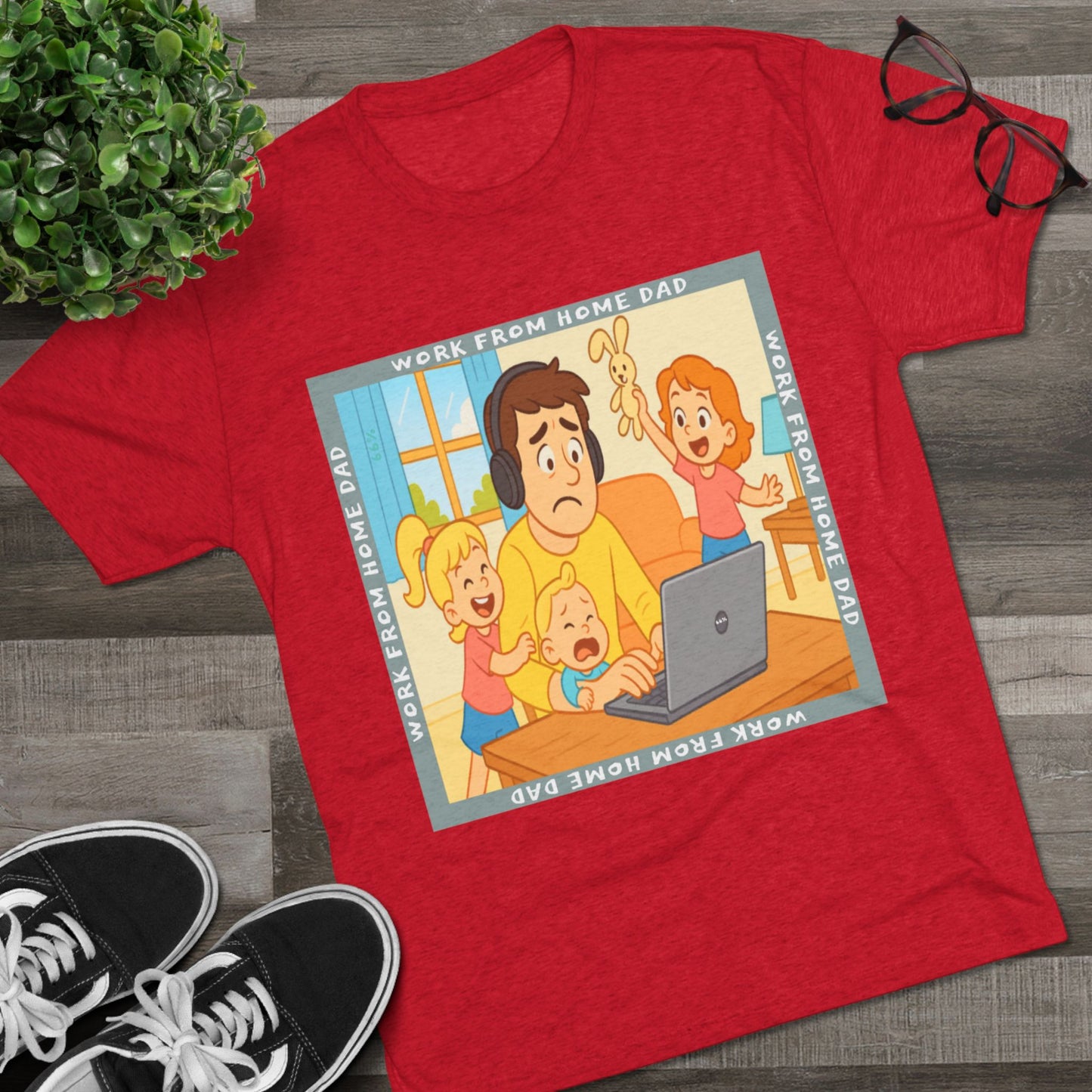 Work From Home Dad 66% Tri-Blend Tee — graphic tee flat-lay, cartoon dad with headphones typing on 66% laptop, three kids demanding attention, green WORK FROM HOME DAD square border, casual unisex style.