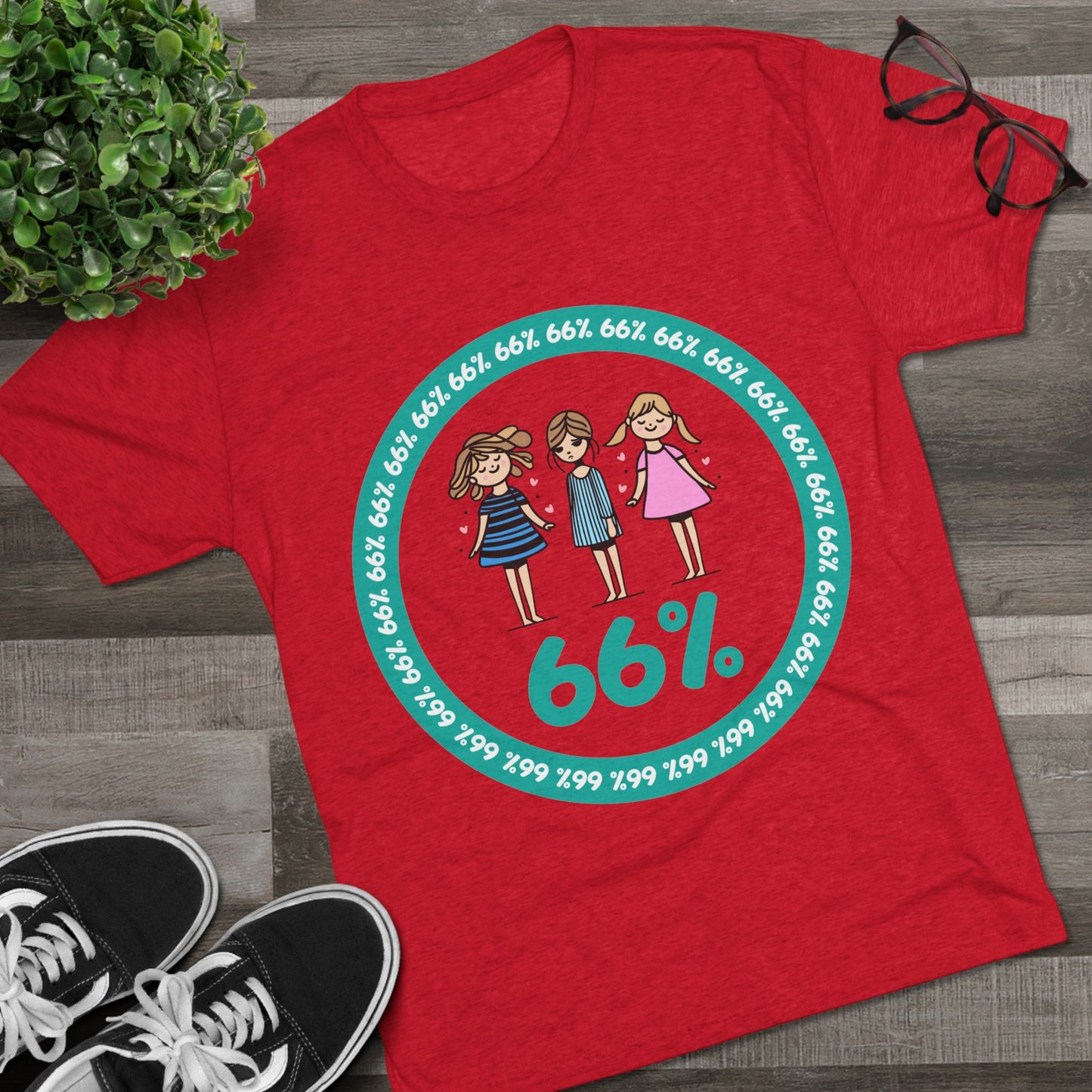 Flat-lay of tri-blend tee with three cartoon girls inside a teal 66% circle and repeating 66% border