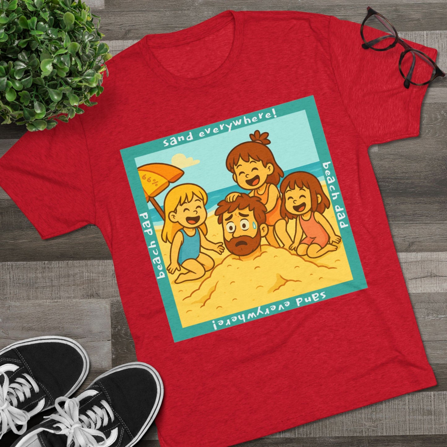 “Beach Dad Buried 66% Tri-Blend Tee — graphic tee flat-lay, cartoon dad sand-buried under umbrella, three kids playing, teal ‘sand everywhere!’ square border, ‘beach dad’ text, unisex casual style.