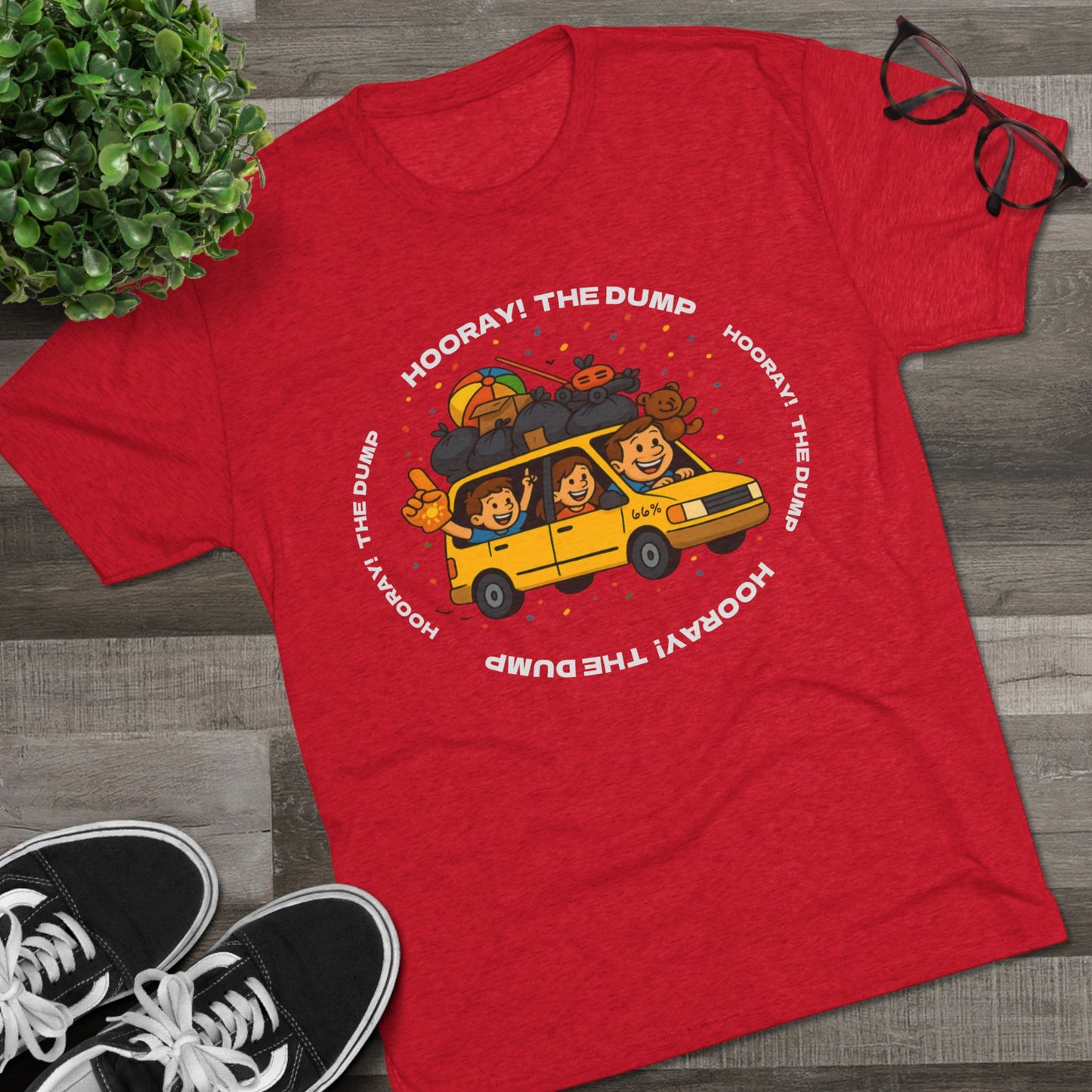 Cartoon yellow “66%” minivan T-shirt design with roof piled high in trash bags, lawnmower and beach ball, plus a dad driving and two excited kids waving with confetti.