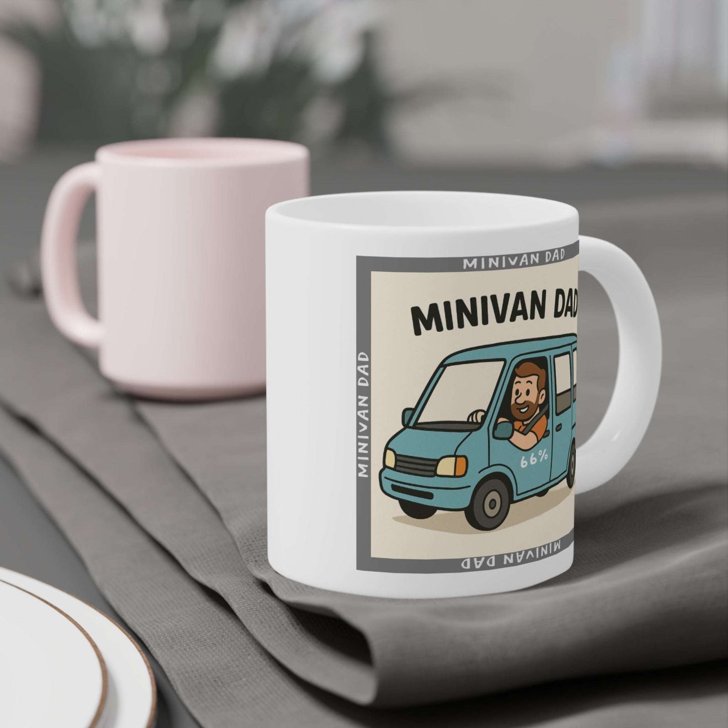 Novelty Minivan Dad coffee mug: white ceramic cup printed with a cheerful father behind the wheel of his minivan and repeating ‘Minivan Dad’ border text.