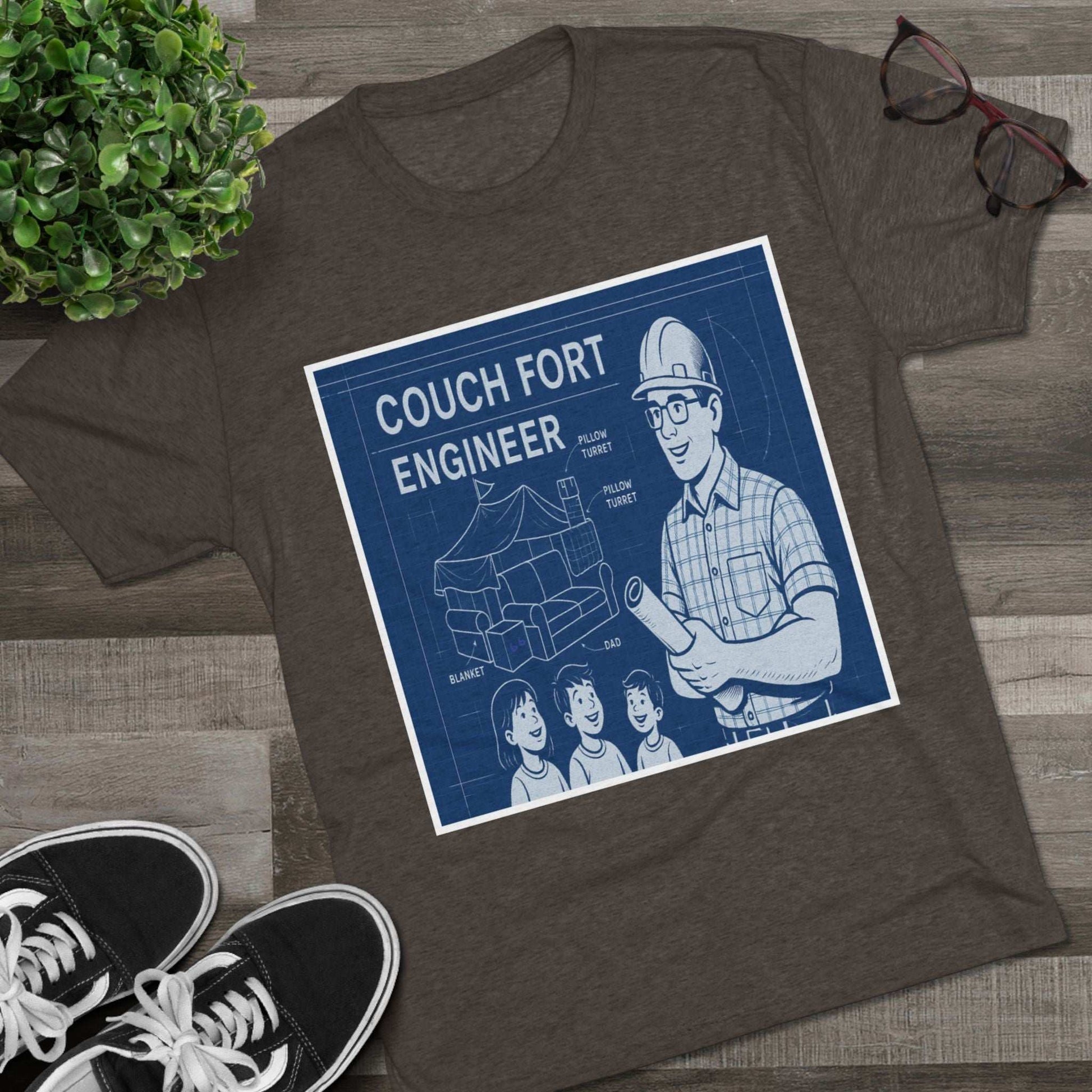 Couch Fort Engineer T-Shirt —Blueprint-style schematic of a couch fort with labeled pillows and blanket, plus a hard-hat dad holding plans.