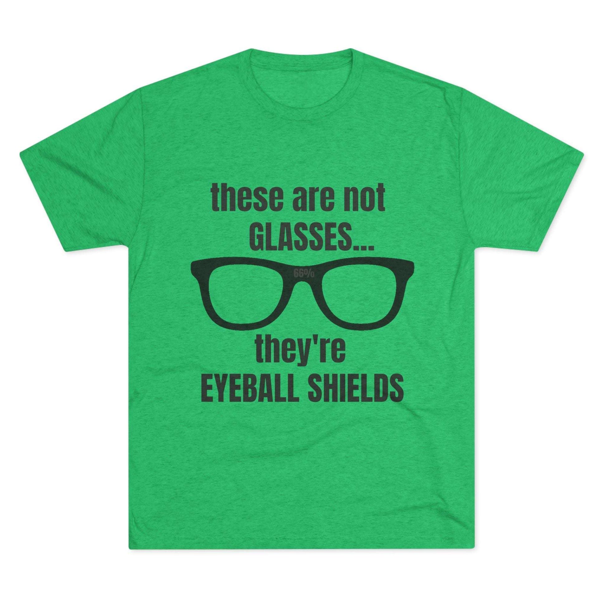 Light heather tri-blend tee flat-laid, printed with black glasses graphic and text ‘these are not GLASSES... they’re EYEBALL SHIELDS.