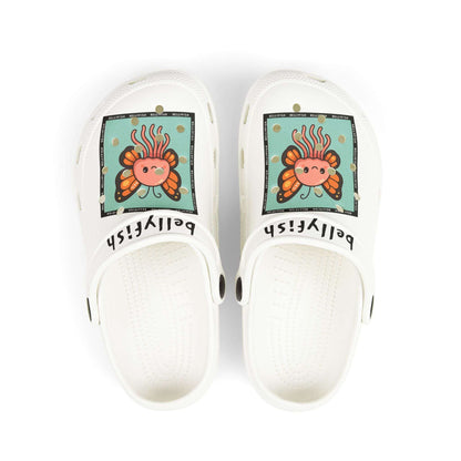 White slip-on clogs decorated with colorful Jibbitz: each shoe has a teal square graphic showing a cute jellyfish with butterfly wings and scattered gold dot accents, plus ‘Bellyfish’ branding on the straps