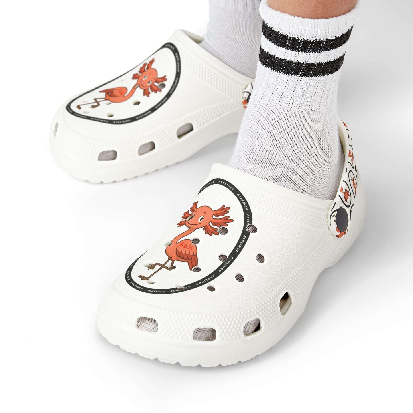 White rubber clogs worn with white-and-black striped socks, each shoe decorated with a round logo depicting a happy orange axolingo and the word ‘AXOLINGO’ repeated around the edge