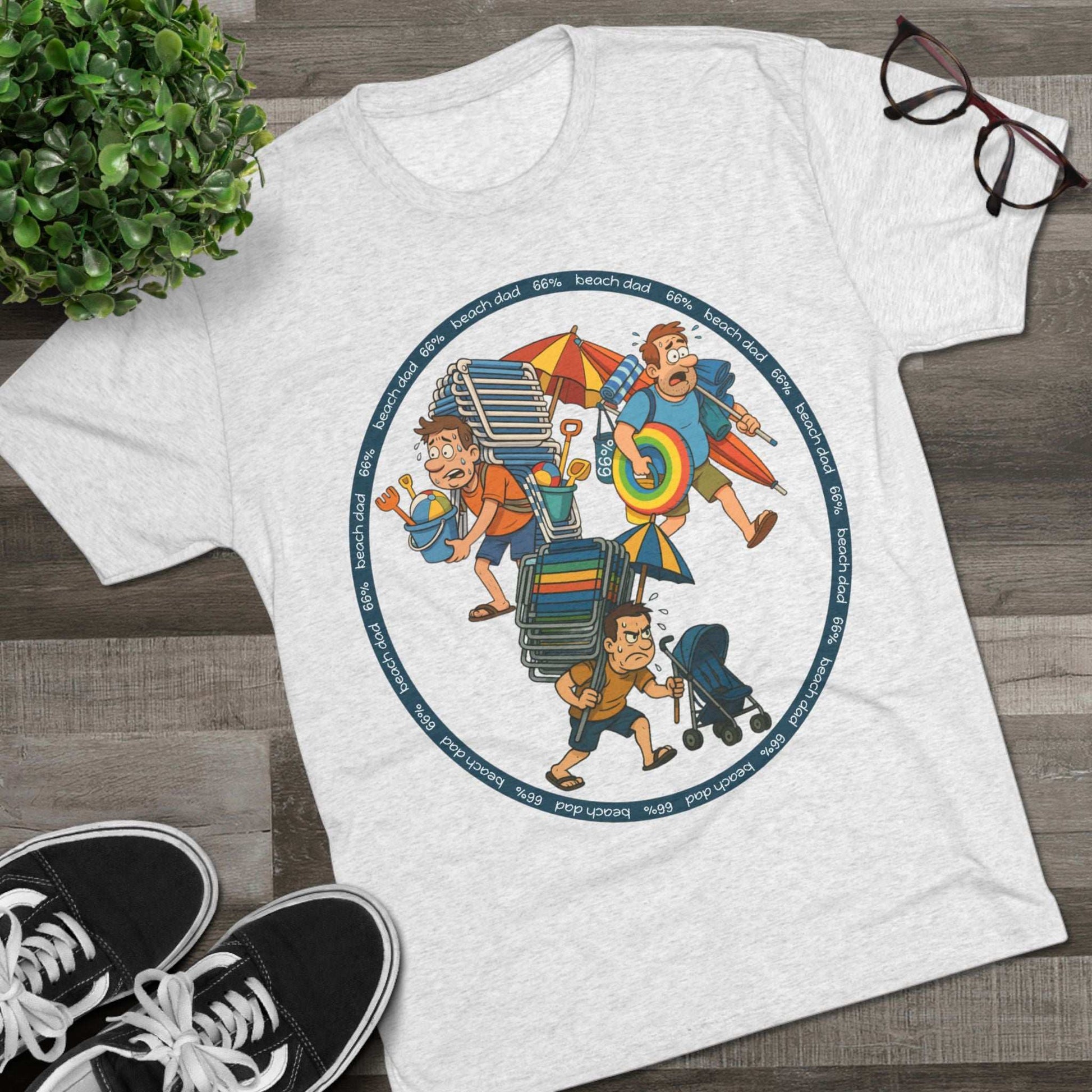 Cartoon dad overloaded with beach gear in three chaotic poses, “Beach Dad 66%” design on bright blue tri-blend tee – funny parenting shirt by 66 Percent