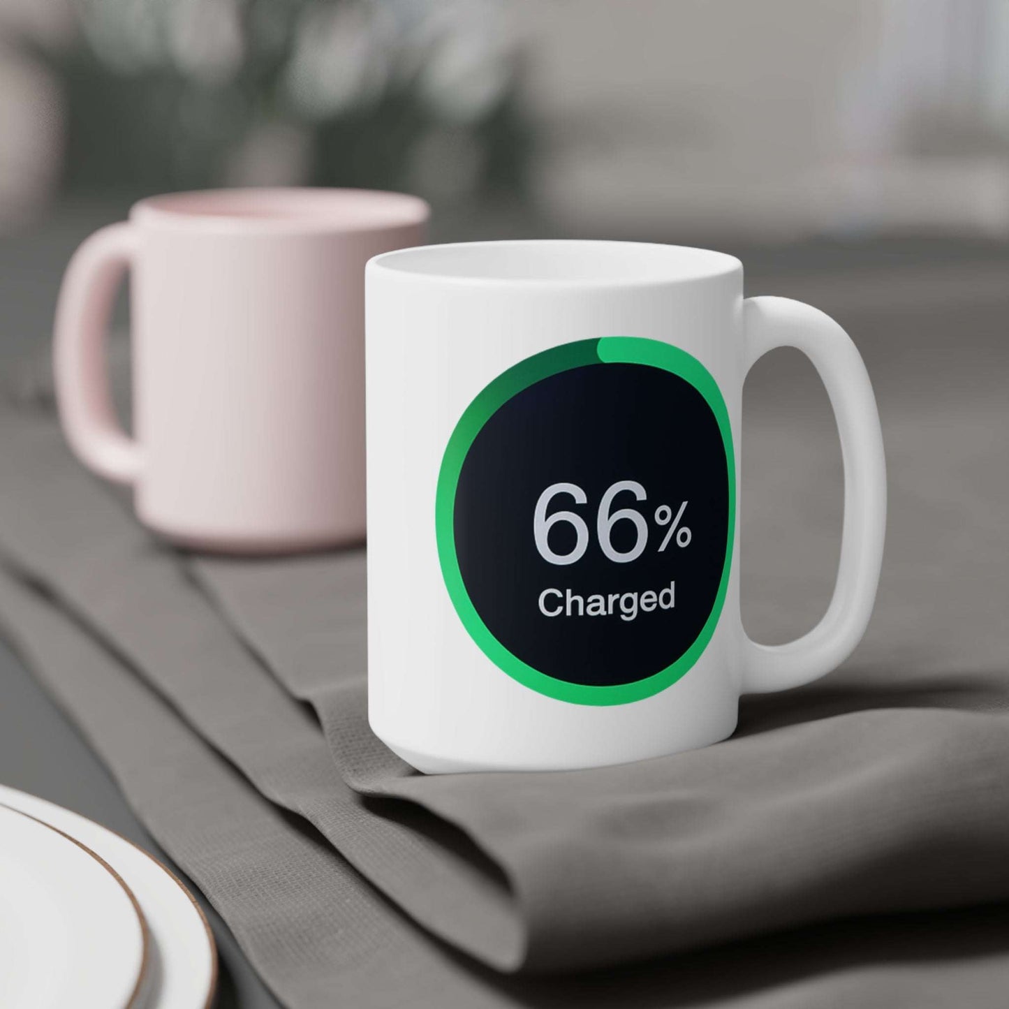 Mug displaying a green-ringed power meter icon reading 66% charged on a black background.