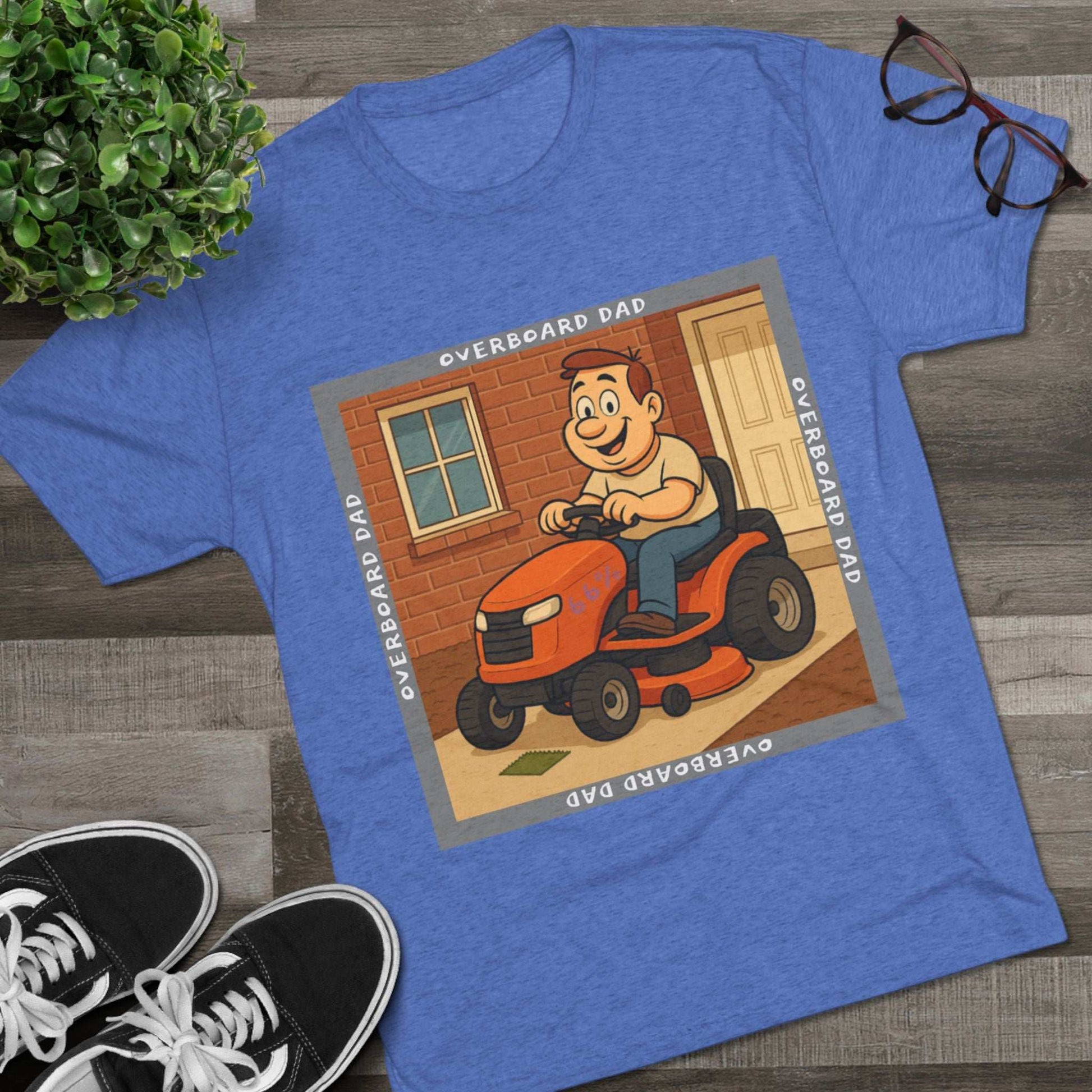 Overboard Dad Mower 66% Tri-Blend Tee — graphic tee, flat-lay with cartoon dad on ride-on mower, gray ‘OVERBOARD DAD’ square border, 66% decal, casual vintage style.