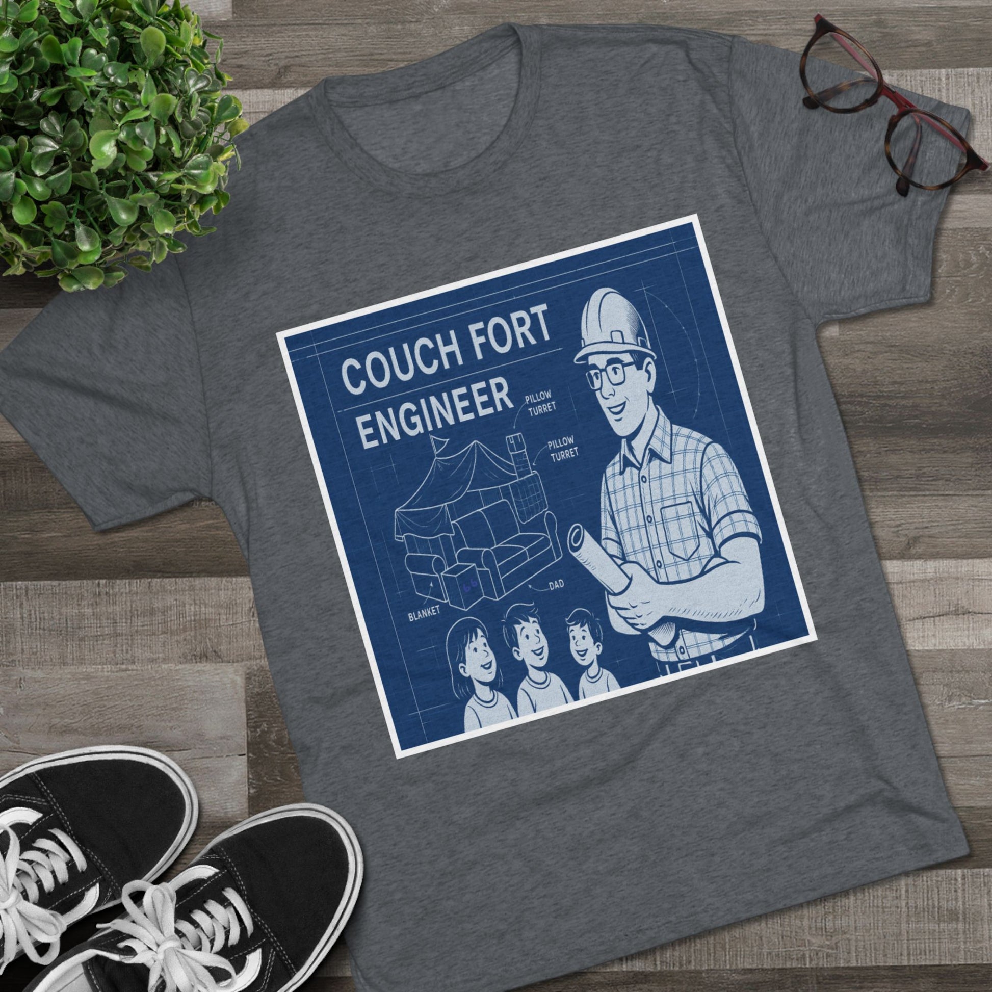 Couch Fort Engineer T-Shirt —Blueprint-style schematic of a couch fort with labeled pillows and blanket, plus a hard-hat dad holding plans.
