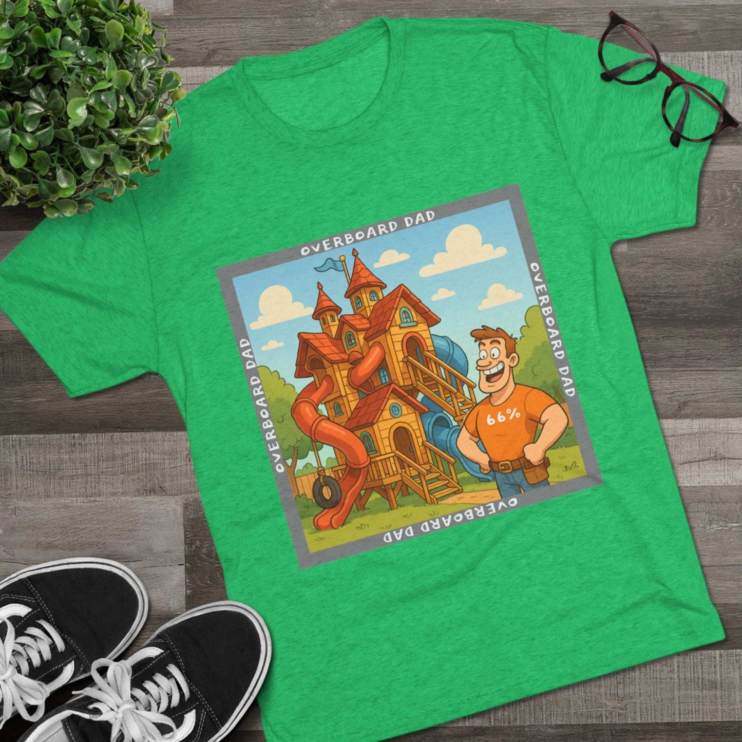 Funny cartoon dad standing proudly beside an enormous playhouse castle with slides, “Overboard Dad 66%” design on bright blue tri-blend t-shirt