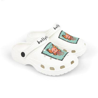 White slip-on clogs decorated with colorful Jibbitz: each shoe has a teal square graphic showing a cute jellyfish with butterfly wings and scattered gold dot accents, plus ‘Bellyfish’ branding on the straps