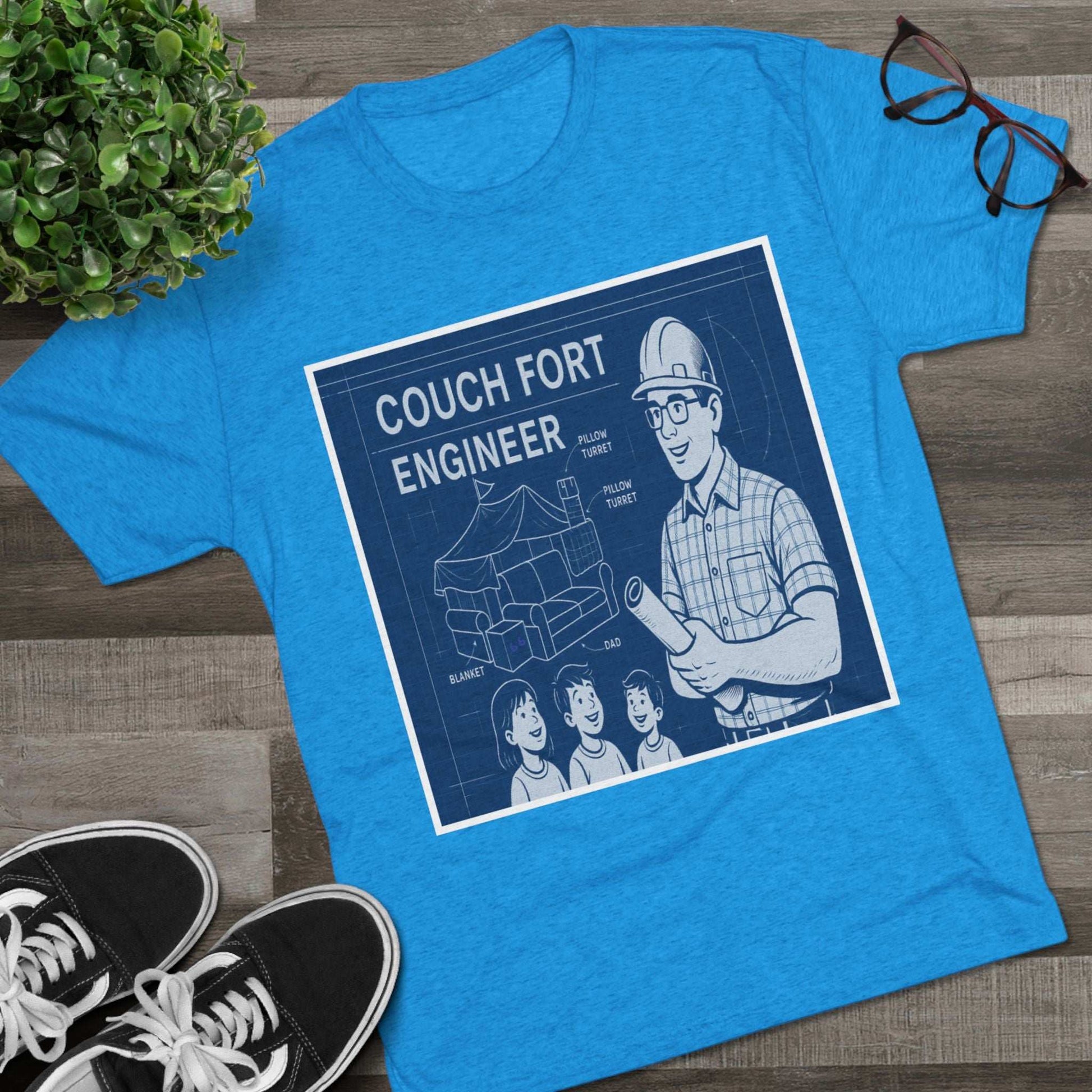 Couch Fort Engineer T-Shirt —Blueprint-style schematic of a couch fort with labeled pillows and blanket, plus a hard-hat dad holding plans.