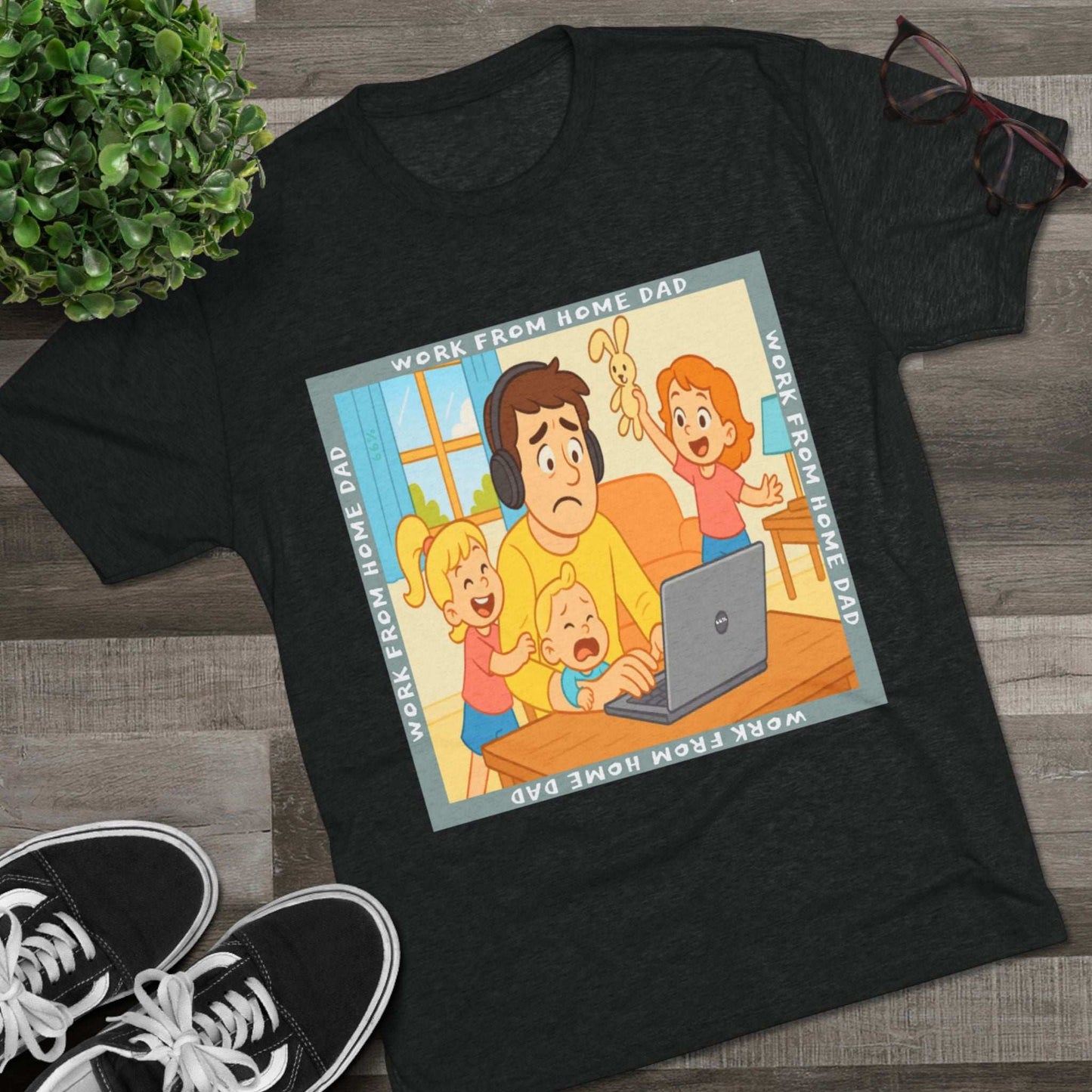 Work From Home Dad 66% Tri-Blend Tee — graphic tee flat-lay, cartoon dad with headphones typing on 66% laptop, three kids demanding attention, green WORK FROM HOME DAD square border, casual unisex style.