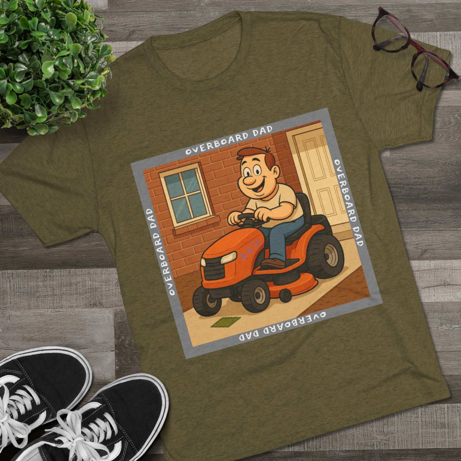 Overboard Dad Mower 66% Tri-Blend Tee — graphic tee, flat-lay with cartoon dad on ride-on mower, gray ‘OVERBOARD DAD’ square border, 66% decal, casual vintage style.