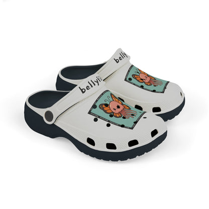 White slip-on clogs decorated with colorful Jibbitz: each shoe has a teal square graphic showing a cute jellyfish with butterfly wings and scattered gold dot accents, plus ‘Bellyfish’ branding on the straps