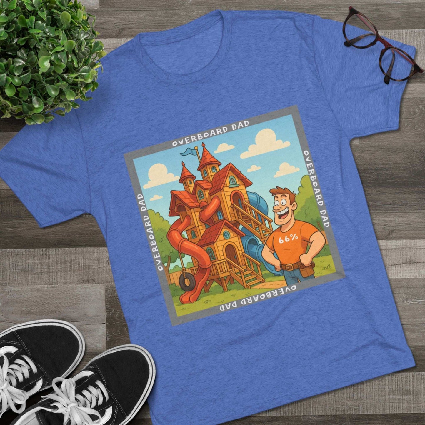 Funny cartoon dad standing proudly beside an enormous playhouse castle with slides, “Overboard Dad 66%” design on bright blue tri-blend t-shirt