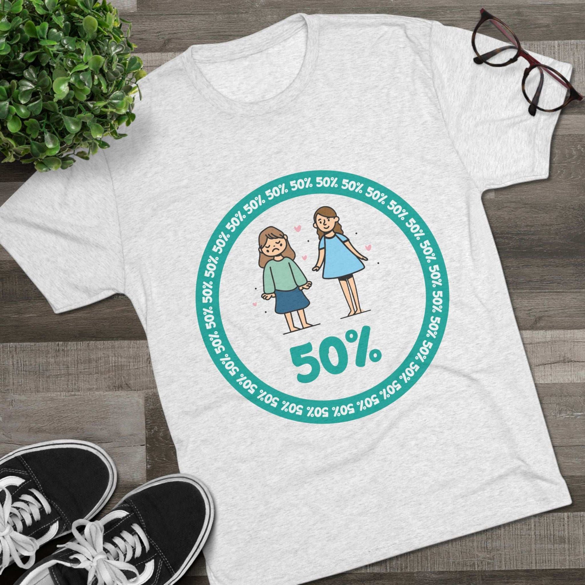 Original Girl Girl 50% Tri-Blend Tee — graphic t-shirt flat-lay, cartoon siblings inside teal 50% circle, repeating 50% pattern, bold 50% text, casual unisex style.