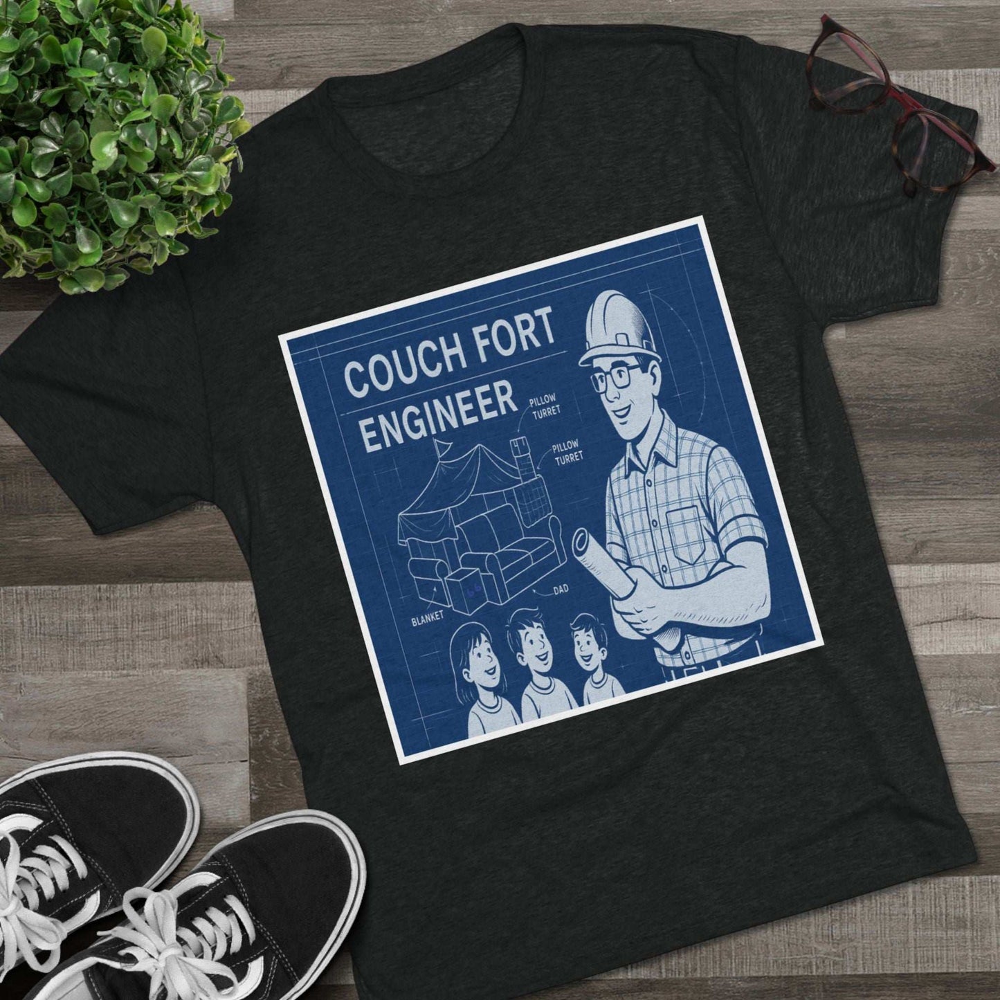 Couch Fort Engineer T-Shirt —Blueprint-style schematic of a couch fort with labeled pillows and blanket, plus a hard-hat dad holding plans.