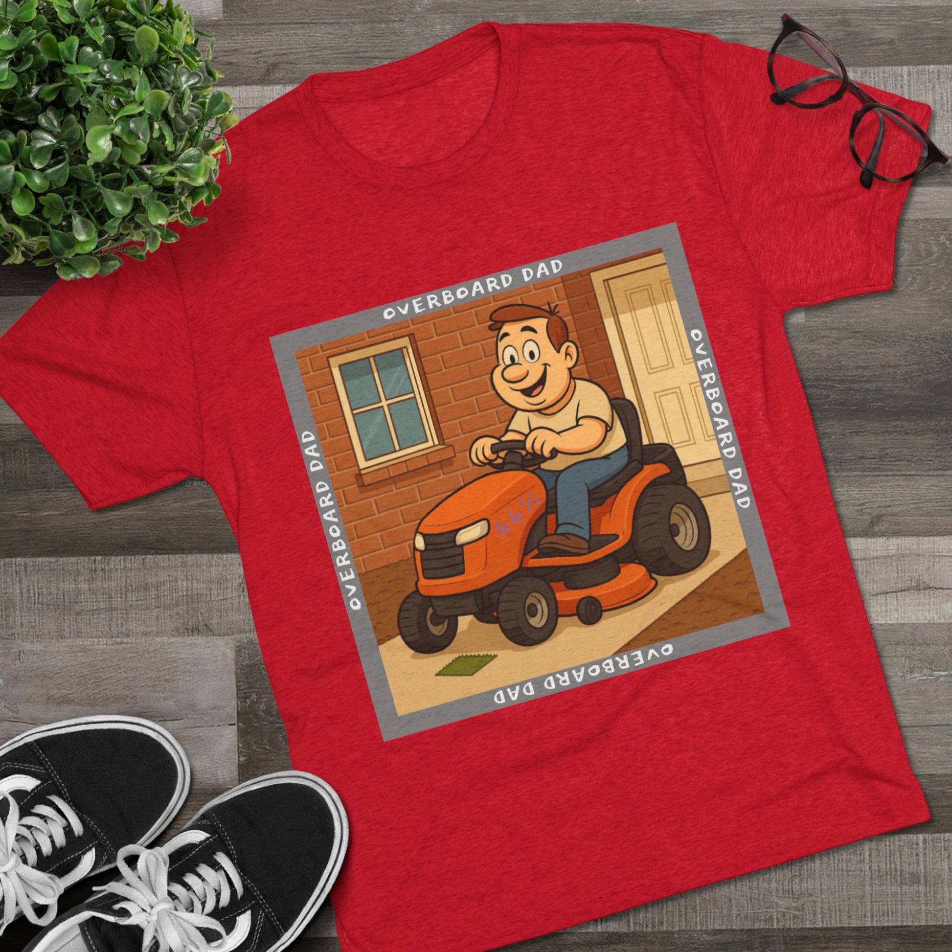 Overboard Dad Mower 66% Tri-Blend Tee — graphic tee, flat-lay with cartoon dad on ride-on mower, gray ‘OVERBOARD DAD’ square border, 66% decal, casual vintage style.