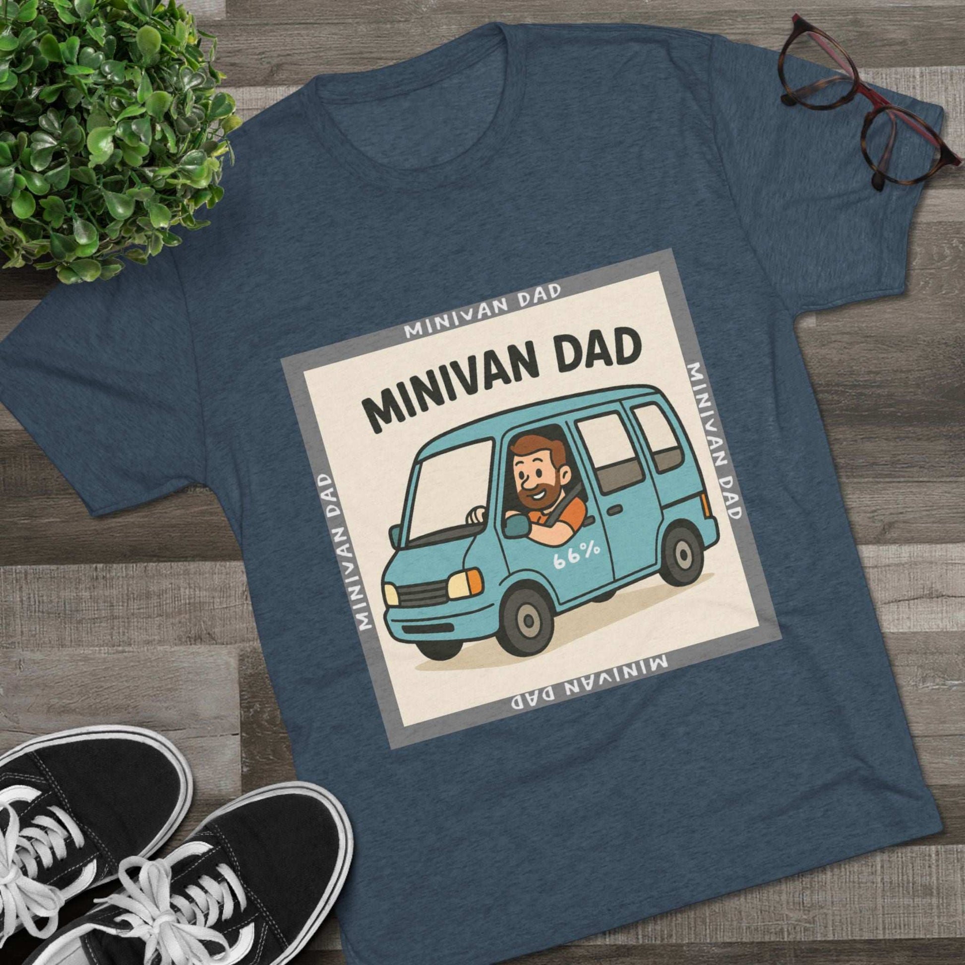 Minivan Dad 66% Tri-Blend Tee — graphic tee flat-lay, cartoon dad driving blue minivan, ‘66%’ decal, gray ‘MINIVAN DAD’ square border, casual unisex style.