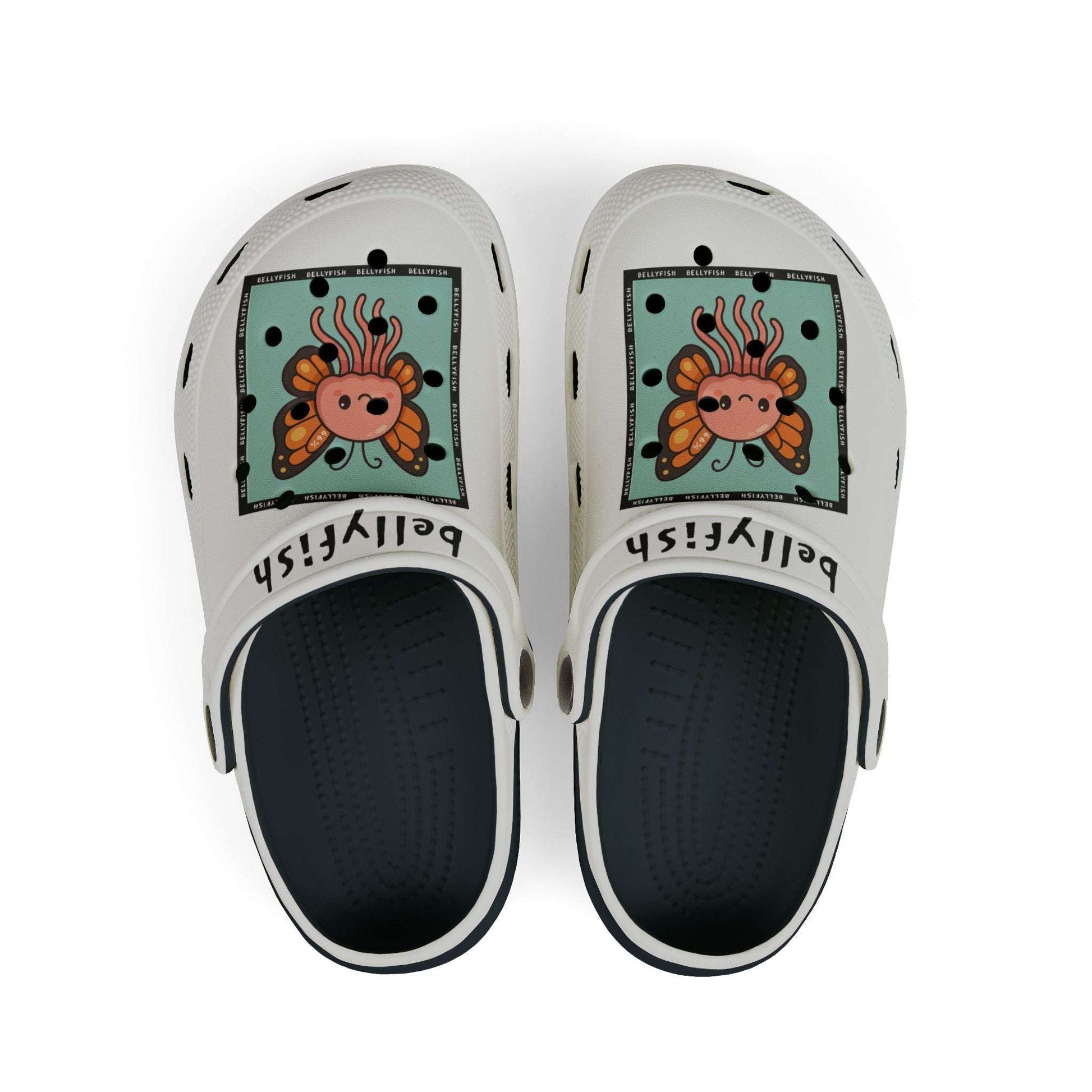 White slip-on clogs decorated with colorful Jibbitz: each shoe has a teal square graphic showing a cute jellyfish with butterfly wings and scattered gold dot accents, plus ‘Bellyfish’ branding on the straps
