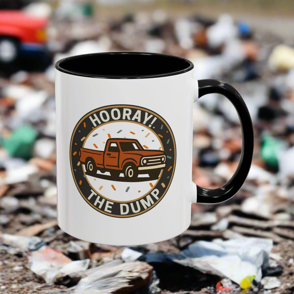 White mug with black interior and handle featuring a truck graphic and text 'Hooray! The Dump'.