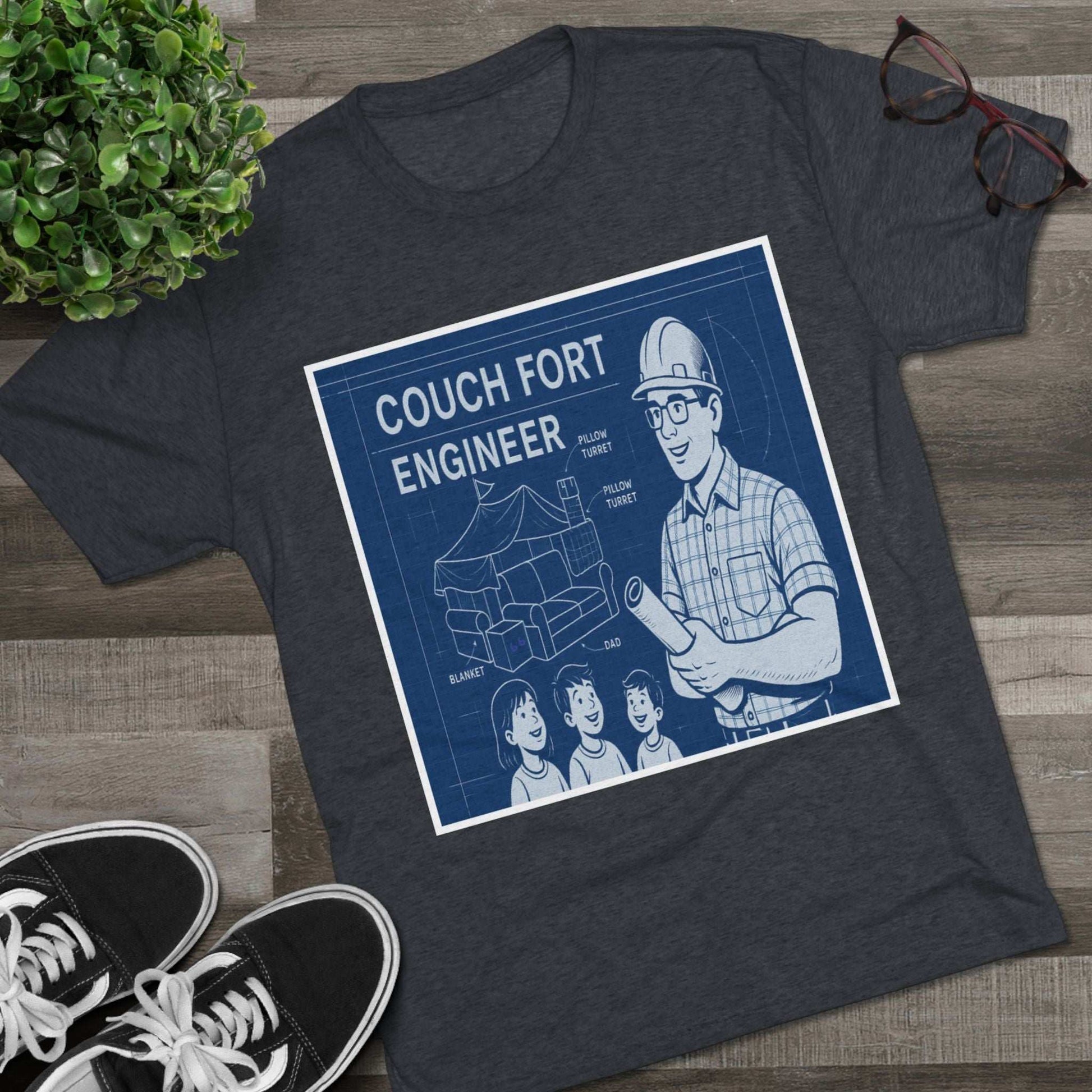 Couch Fort Engineer T-Shirt —Blueprint-style schematic of a couch fort with labeled pillows and blanket, plus a hard-hat dad holding plans.