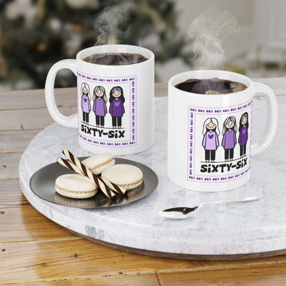 Coffee mug printed with a purple-bordered illustration: three girls in matching purple tops (one looking unhappy), encircled by ‘66%’ text, and the caption ‘SIXTY-SIX’ underneath.