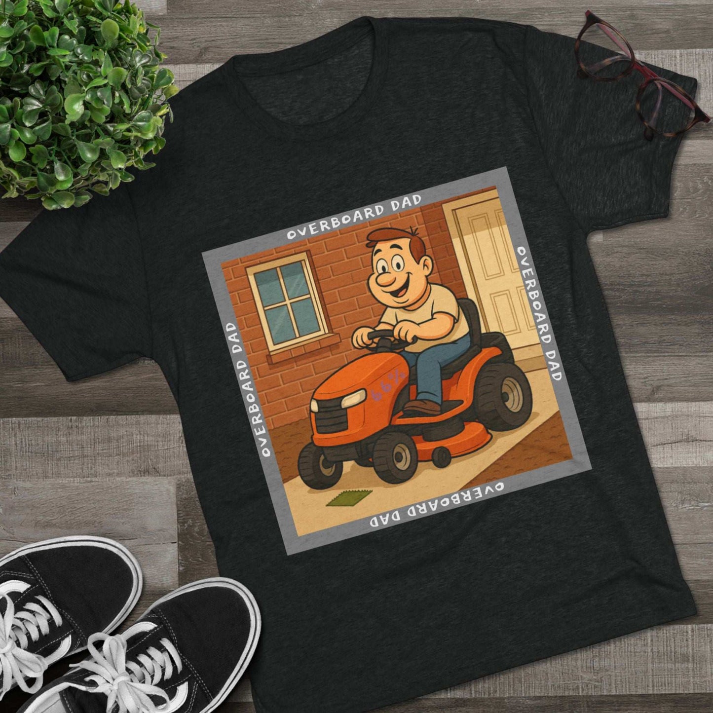 Overboard Dad Mower 66% Tri-Blend Tee — graphic tee, flat-lay with cartoon dad on ride-on mower, gray ‘OVERBOARD DAD’ square border, 66% decal, casual vintage style.