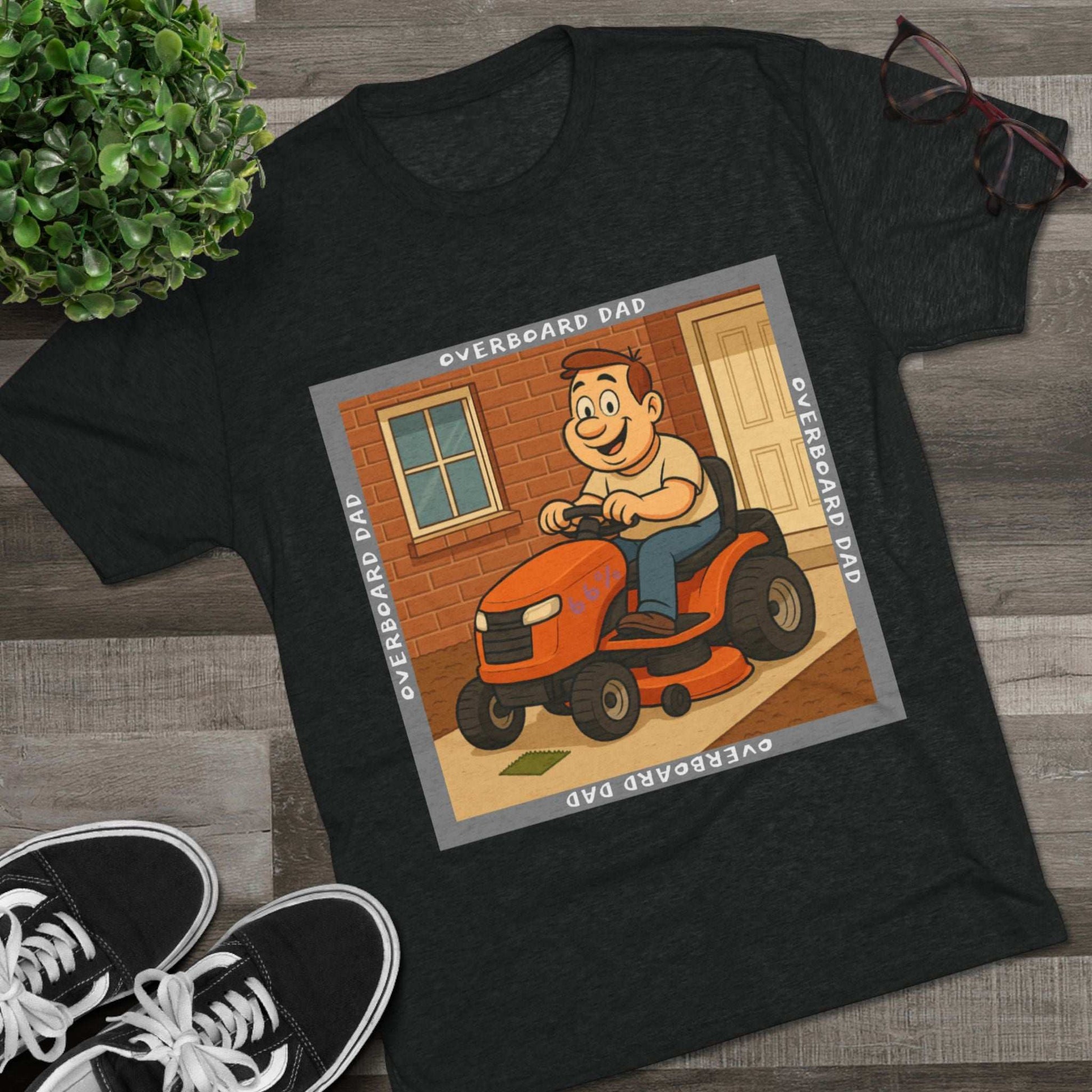 Overboard Dad Mower 66% Tri-Blend Tee — graphic tee, flat-lay with cartoon dad on ride-on mower, gray ‘OVERBOARD DAD’ square border, 66% decal, casual vintage style.