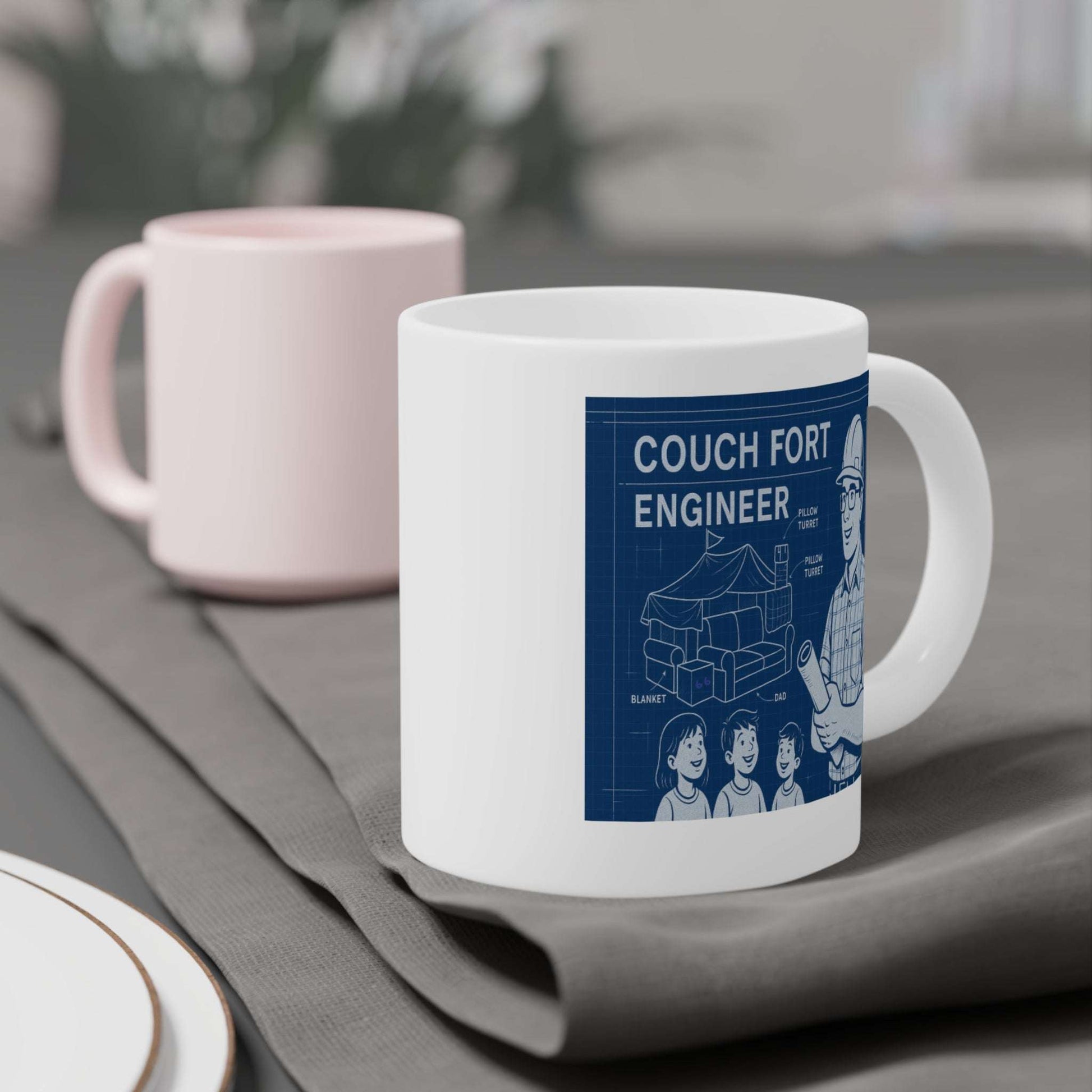 Blueprint-themed mug design reading ‘Couch Fort Engineer,’ depicting a dad wearing safety glasses and hardhat holding a plan, alongside a cutaway diagram of a living-room couch fort and three happy kids.