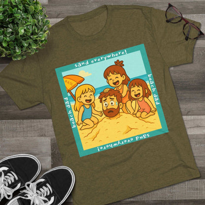 “Beach Dad Buried 66% Tri-Blend Tee — graphic tee flat-lay, cartoon dad sand-buried under umbrella, three kids playing, teal ‘sand everywhere!’ square border, ‘beach dad’ text, unisex casual style.