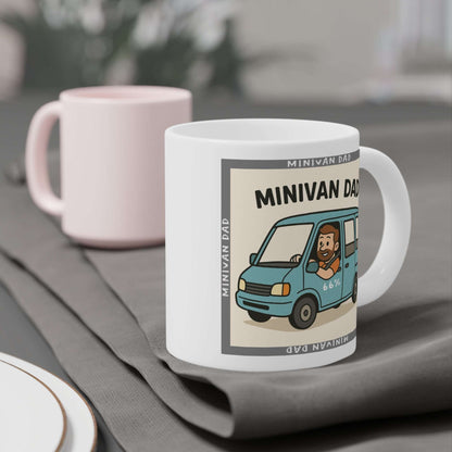 Novelty Minivan Dad coffee mug: white ceramic cup printed with a cheerful father behind the wheel of his minivan and repeating ‘Minivan Dad’ border text.