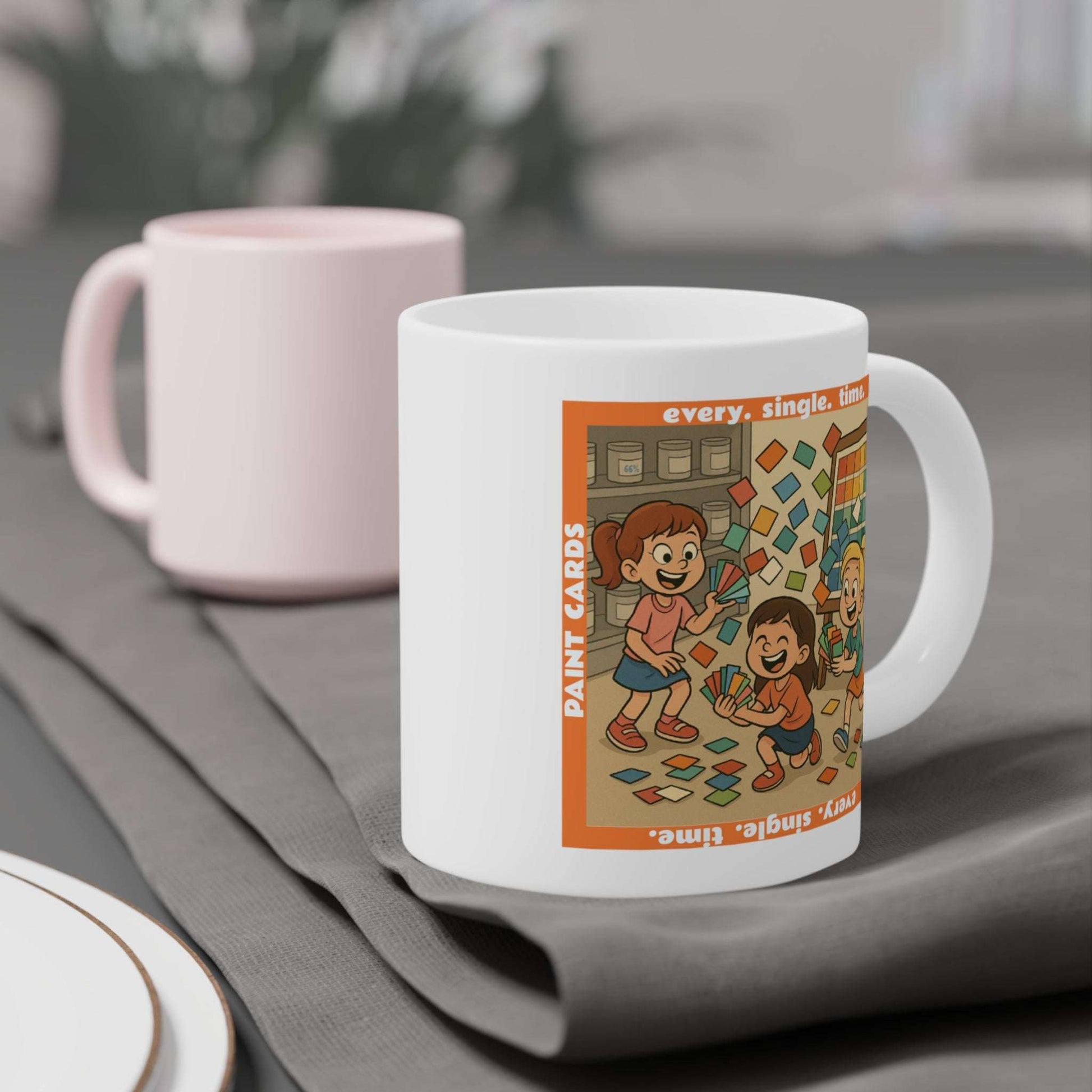 Coffee mug featuring a whimsical illustration of three children holding and tossing colorful paint sample cards in front of a paint shelf, with the text ‘every. single. time.’ and ‘Paint Cards’ framing the scene.