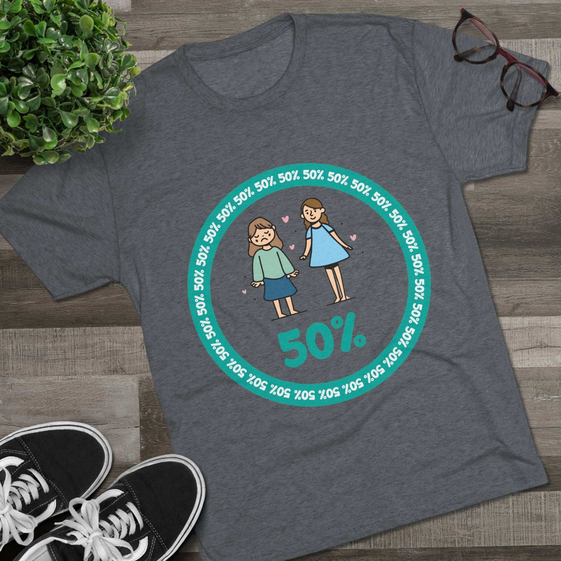 Original Girl Girl 50% Tri-Blend Tee — graphic t-shirt flat-lay, cartoon siblings inside teal 50% circle, repeating 50% pattern, bold 50% text, casual unisex style.