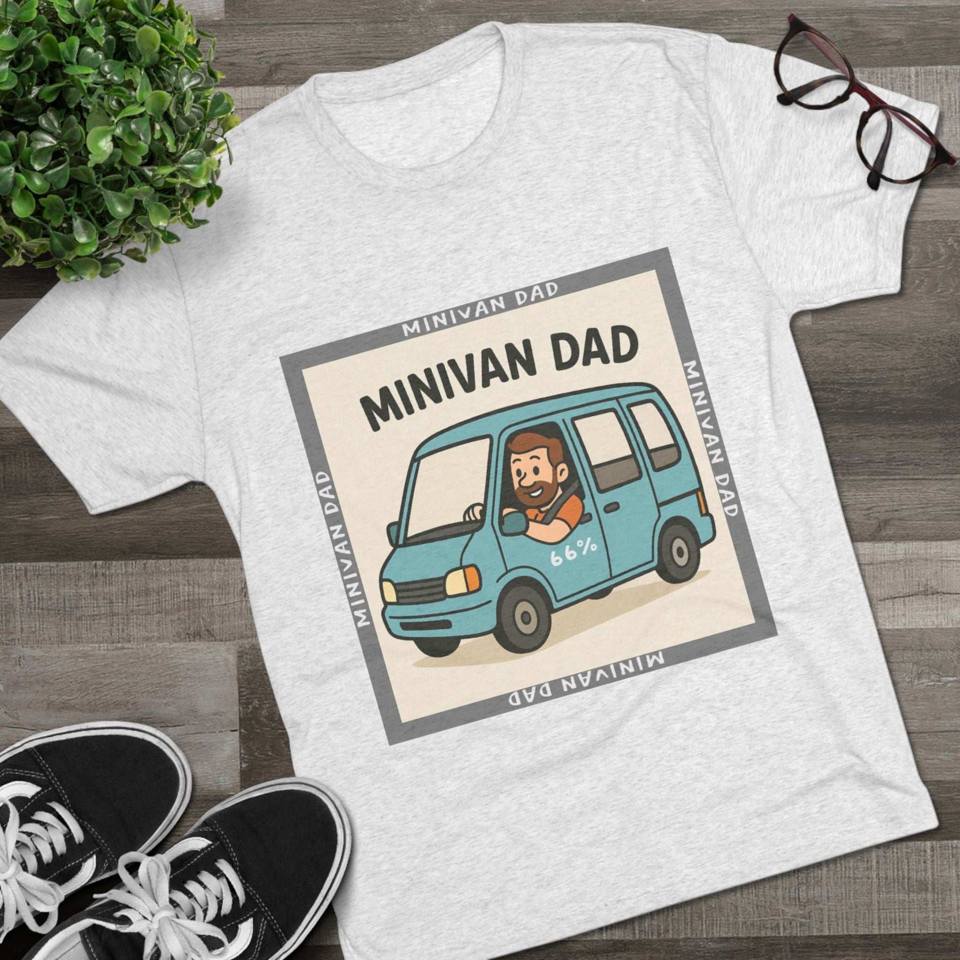 Minivan Dad 66% Tri-Blend Tee — graphic tee flat-lay, cartoon dad driving blue minivan, ‘66%’ decal, gray ‘MINIVAN DAD’ square border, casual unisex style.