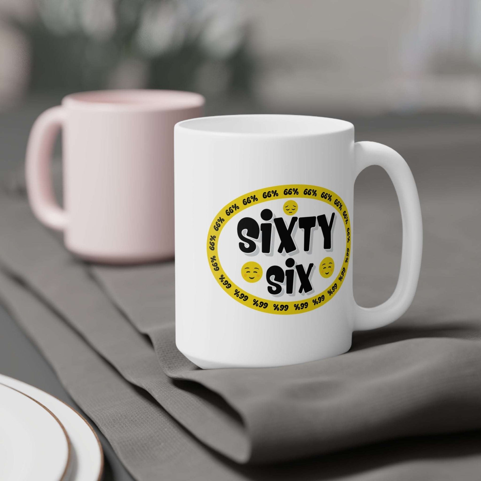 Graphic mug showing ‘Sixty Six’ in bold black type surrounded by a yellow border of small ‘66%’ repeats, with 2 cheerful emoji faces and 1 sad face.
