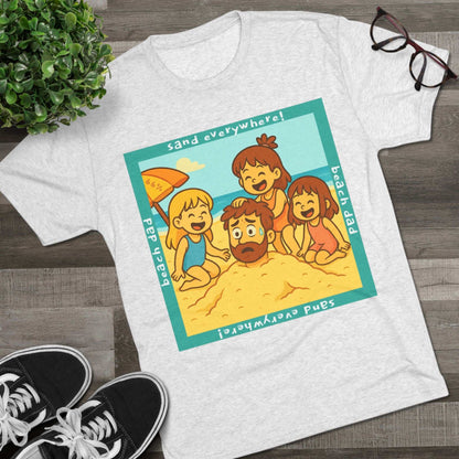 “Beach Dad Buried 66% Tri-Blend Tee — graphic tee flat-lay, cartoon dad sand-buried under umbrella, three kids playing, teal ‘sand everywhere!’ square border, ‘beach dad’ text, unisex casual style.