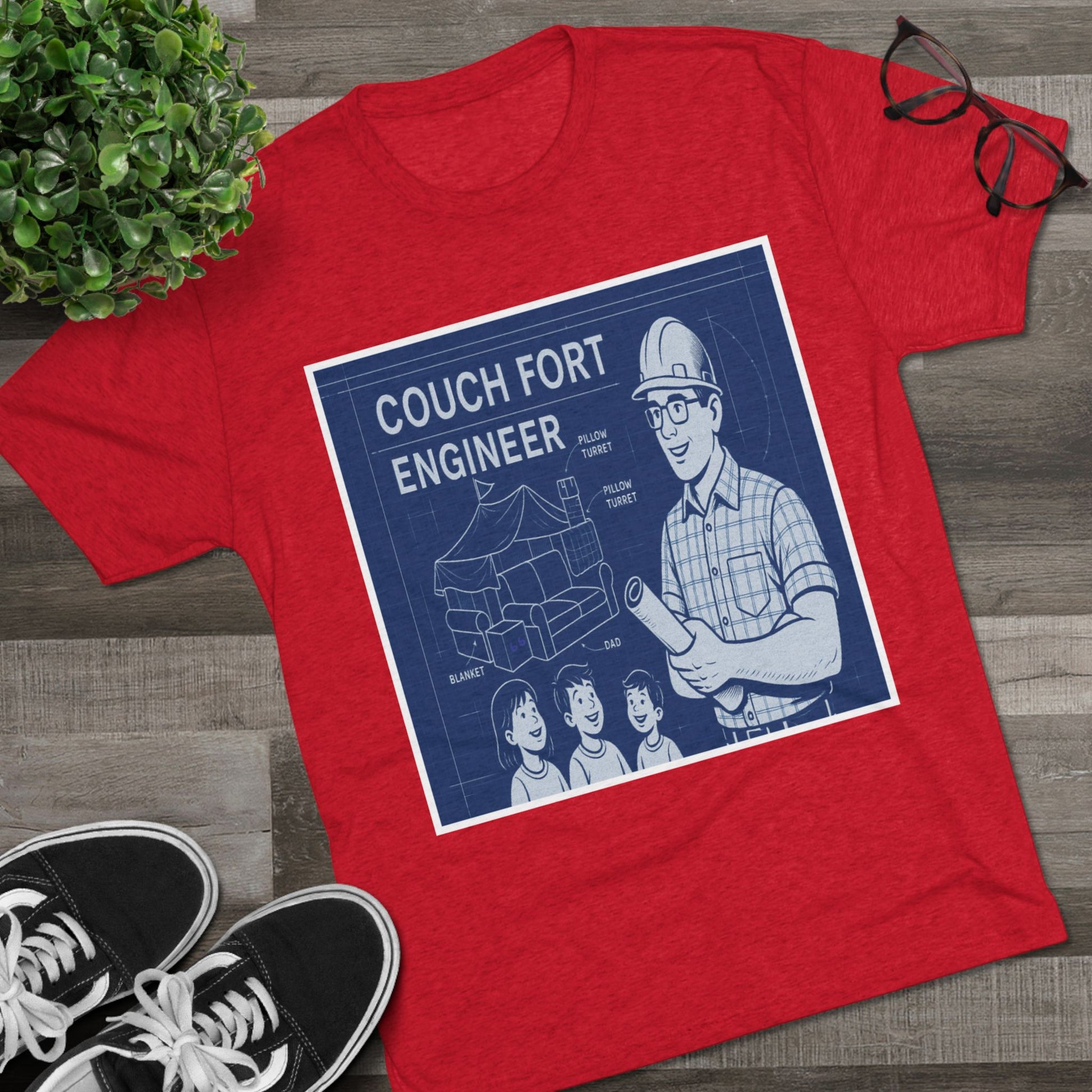 Couch Fort Engineer T-Shirt —Blueprint-style schematic of a couch fort with labeled pillows and blanket, plus a hard-hat dad holding plans.