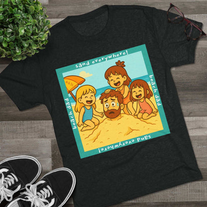 “Beach Dad Buried 66% Tri-Blend Tee — graphic tee flat-lay, cartoon dad sand-buried under umbrella, three kids playing, teal ‘sand everywhere!’ square border, ‘beach dad’ text, unisex casual style.