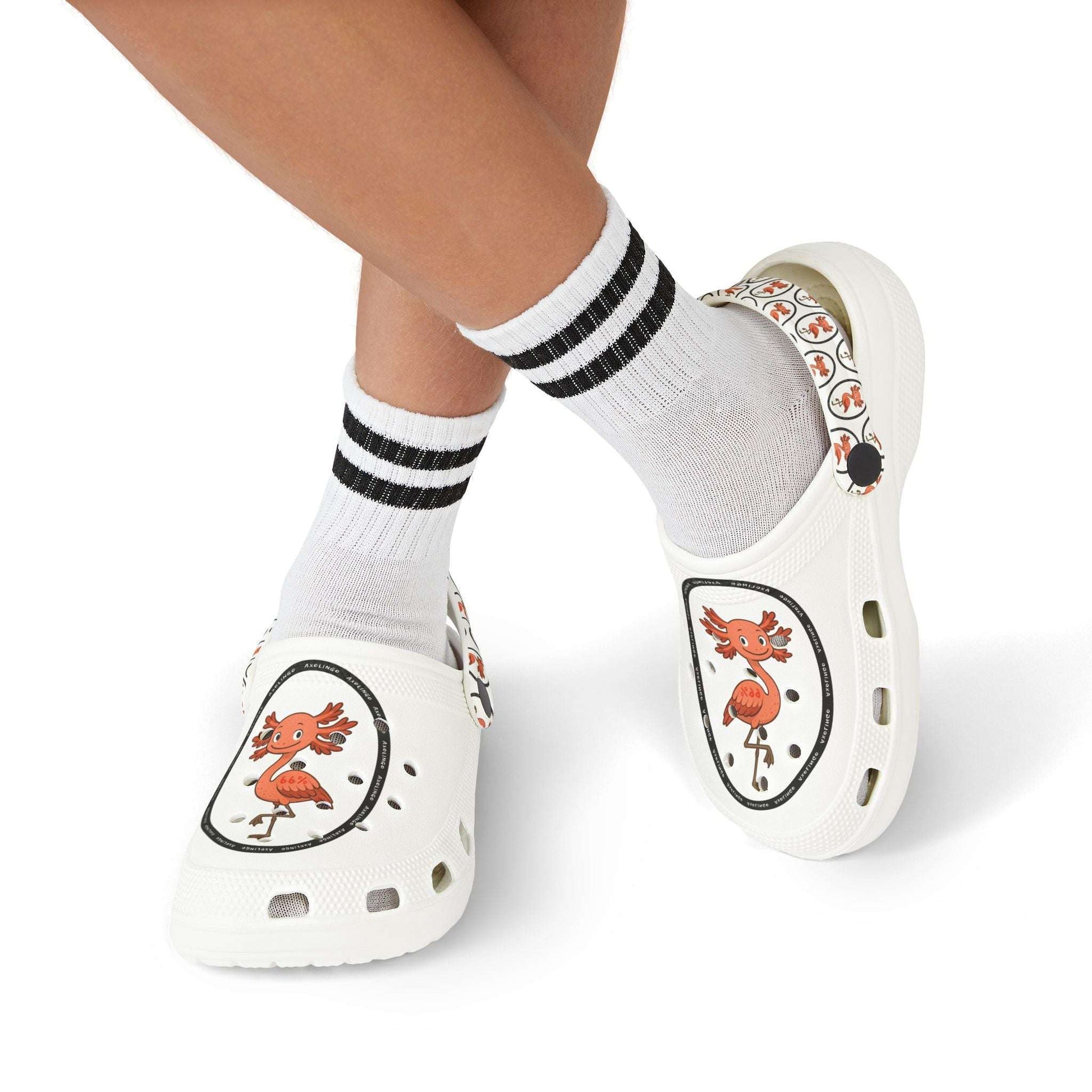 White rubber clogs worn with white-and-black striped socks, each shoe decorated with a round logo depicting a happy orange axolingo and the word ‘AXOLINGO’ repeated around the edge